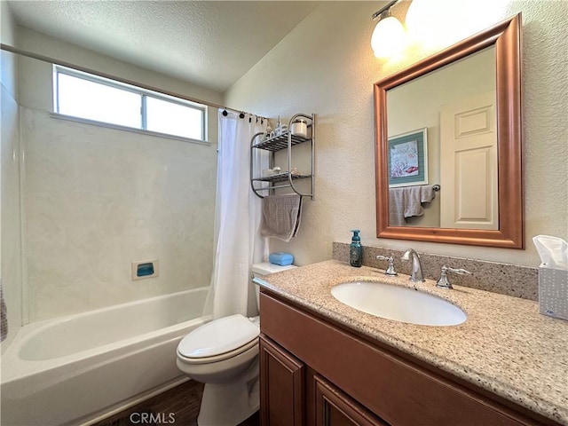full bath featuring a textured wall, vanity, toilet, shower / bathtub combination with curtain, and wood finished floors