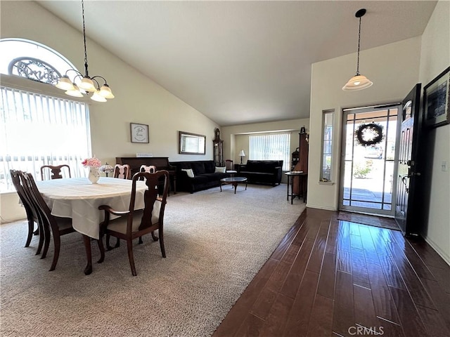dining room featuring high vaulted ceiling, baseboards, dark wood-style flooring, and a chandelier