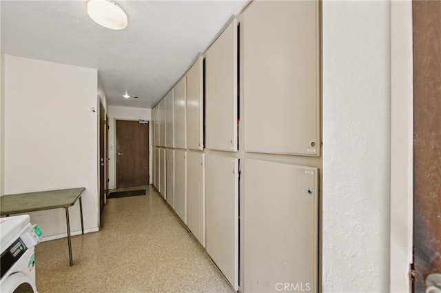 hall with washer / clothes dryer and baseboards