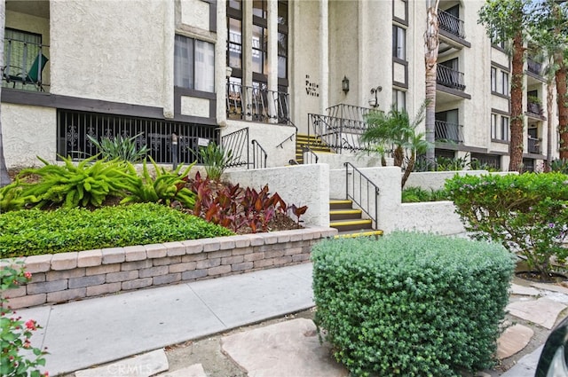 entrance to property featuring stucco siding