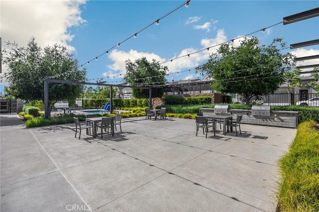 view of patio / terrace with outdoor dining area, fence, and grilling area
