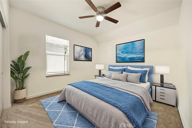 bedroom featuring baseboards, light carpet, and ceiling fan