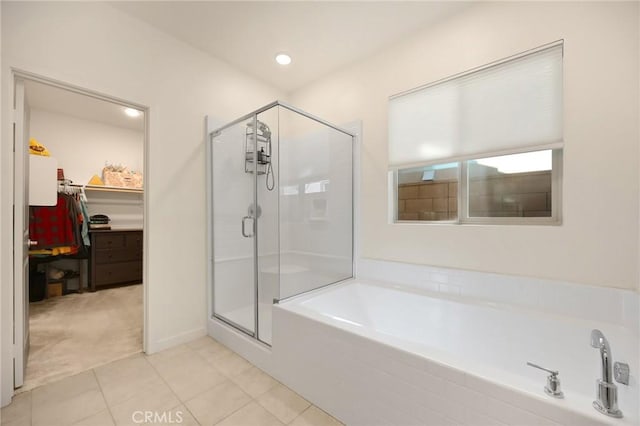 full bathroom featuring a garden tub, recessed lighting, tile patterned floors, a spacious closet, and a shower stall