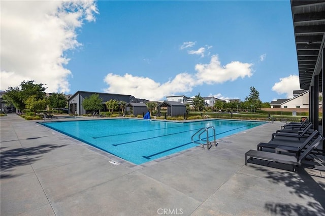pool featuring a patio and a residential view