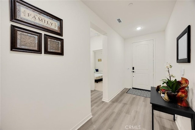 interior space featuring baseboards, recessed lighting, light wood-style flooring, and visible vents