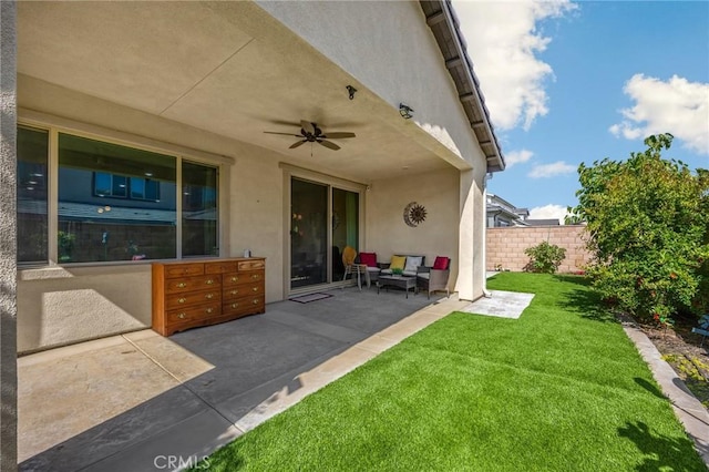 view of patio / terrace with a ceiling fan, fence, and mail area