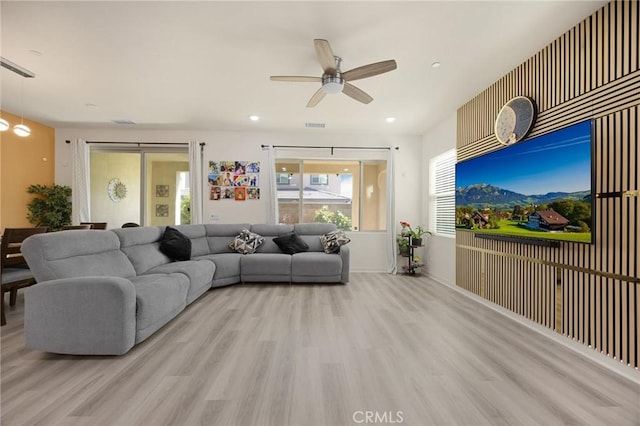 living room featuring a ceiling fan, visible vents, wood finished floors, and recessed lighting