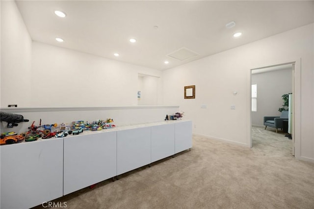 interior space featuring recessed lighting, baseboards, light carpet, and attic access