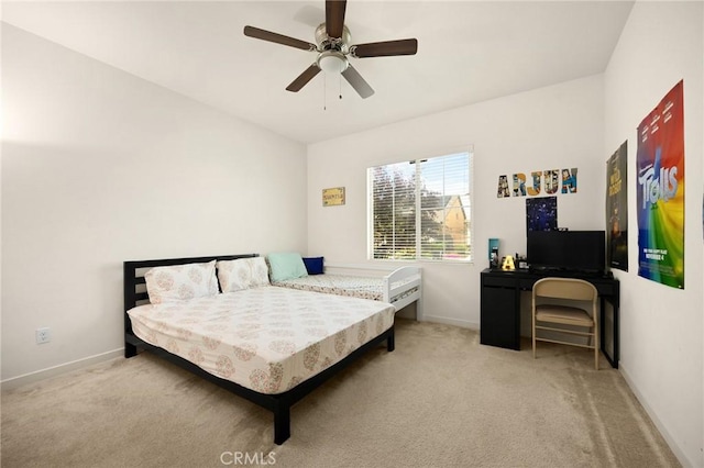 bedroom featuring baseboards, ceiling fan, and light carpet