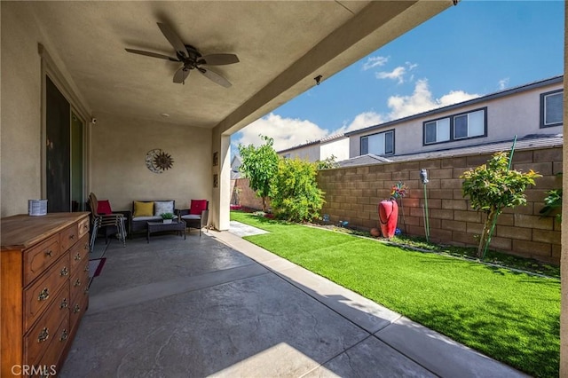 view of patio featuring a fenced backyard, ceiling fan, and outdoor lounge area
