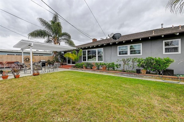rear view of house with fence, a pergola, stucco siding, a patio, and a yard