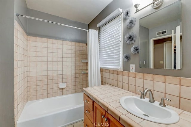 full bathroom featuring vanity, decorative backsplash, shower / bath combo with shower curtain, and visible vents