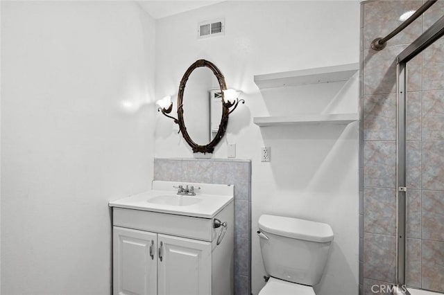 572 E Ghent St, San Dimas, CA 91773 - bathroom featuring vanity, a tile shower, toilet, and visible vents