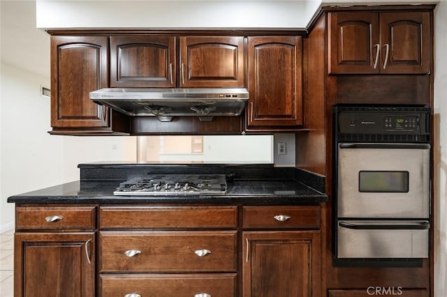 572 E Ghent St, San Dimas, CA 91773 - kitchen with dark brown cabinets, appliances with stainless steel finishes, dark stone countertops, under cabinet range hood, and a warming drawer