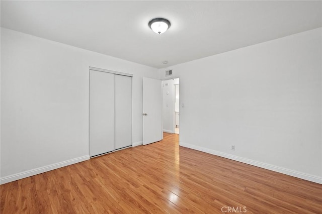 572 E Ghent St, San Dimas, CA 91773 - unfurnished bedroom featuring baseboards, visible vents, light wood finished floors, and a closet