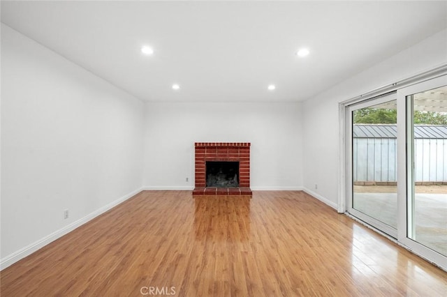 572 E Ghent St, San Dimas, CA 91773 - unfurnished living room with recessed lighting, light wood finished floors, a brick fireplace, and baseboards