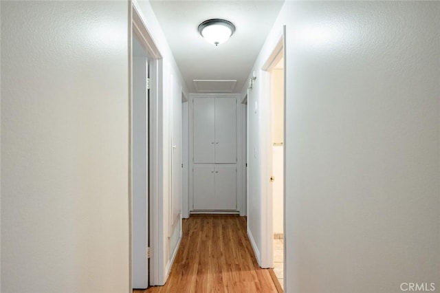 572 E Ghent St, San Dimas, CA 91773 - corridor featuring baseboards, attic access, and light wood-style flooring