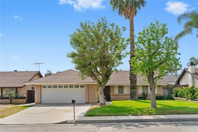 single story home with fence, a front yard, stucco siding, an attached garage, and driveway