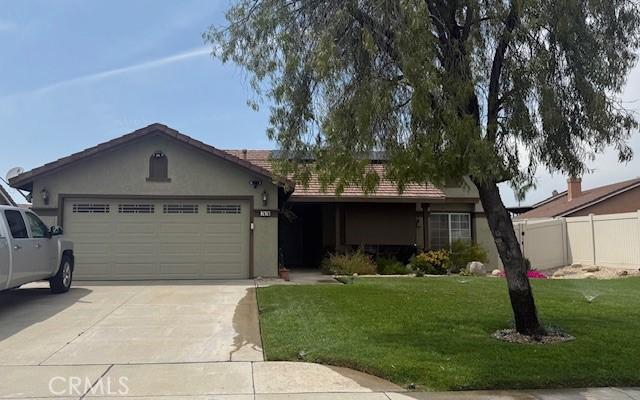 single story home with fence, a front lawn, a garage, stucco siding, and concrete driveway
