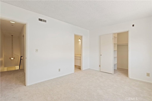 9502 Via Salerno, Burbank, CA 91504 - unfurnished bedroom featuring light colored carpet, a spacious closet, a textured ceiling, ensuite bathroom, and a closet