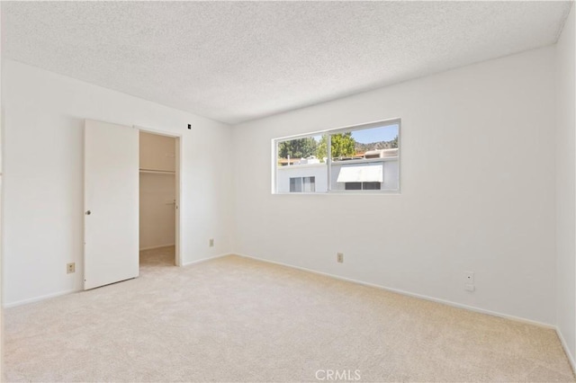 9502 Via Salerno, Burbank, CA 91504 - unfurnished bedroom with light carpet, a spacious closet, a textured ceiling, a closet, and baseboards