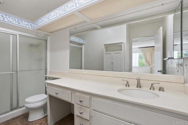 full bathroom with vanity, a shower stall, and toilet