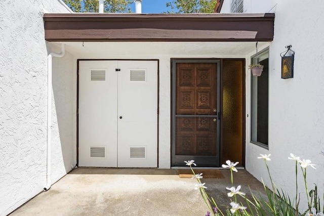 property entrance featuring stucco siding