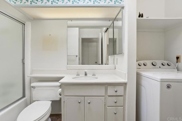 full bathroom with vanity, shower / bath combination with glass door, washer / clothes dryer, and toilet