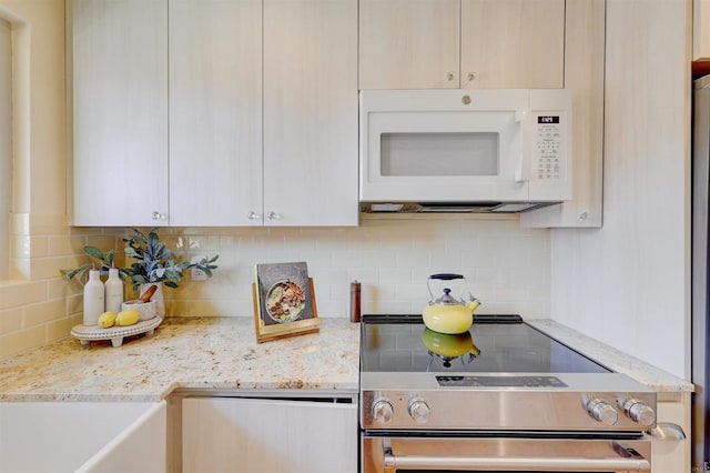 1982 Fairlee Dr, Encinitas, CA 92024 - kitchen featuring white microwave, stainless steel range with electric cooktop, decorative backsplash, and light stone countertops