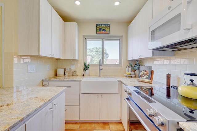 1982 Fairlee Dr, Encinitas, CA 92024 - kitchen with white microwave, a sink, electric stove, decorative backsplash, and recessed lighting
