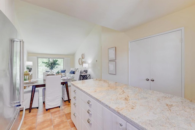 1982 Fairlee Dr, Encinitas, CA 92024 - kitchen with light stone counters, open floor plan, high end fridge, light tile patterned floors, and lofted ceiling