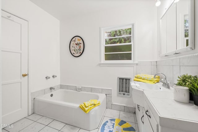 full bath featuring vanity, a bath, and visible vents