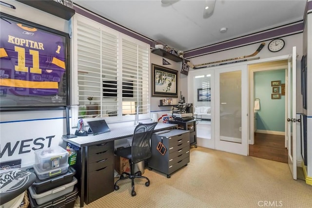 carpeted home office with french doors