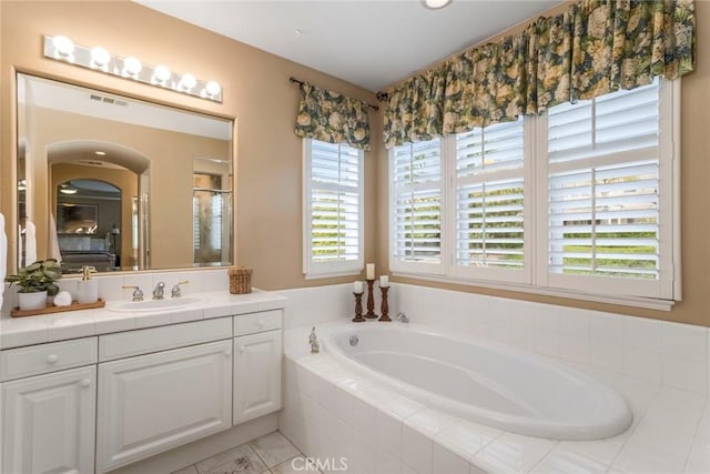 bathroom featuring a shower with door, tile patterned flooring, a bath, and vanity