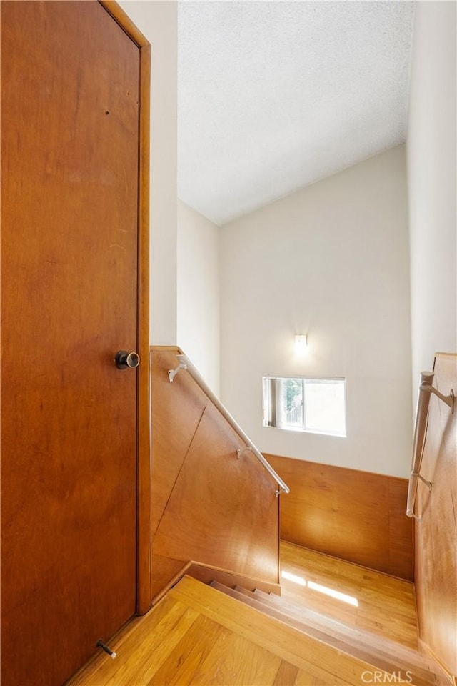 stairway featuring wood finished floors