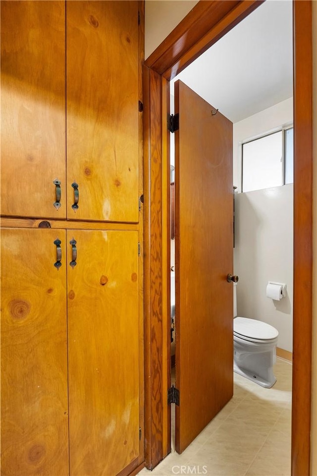 bathroom featuring tile patterned floors and toilet