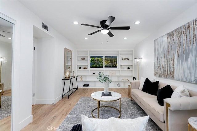 1061 Colby Cir, Thousand Oaks, CA 91362 - living area with wood finished floors, ceiling fan, built in shelves, baseboards, and recessed lighting