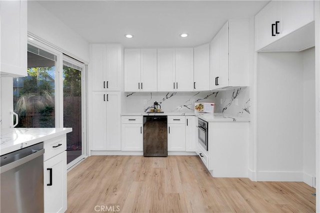 1061 Colby Cir, Thousand Oaks, CA 91362 - kitchen featuring dishwasher, light wood finished floors, white cabinets, recessed lighting, and black oven