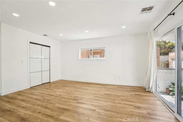 3427 S Victoria Ave, Los Angeles, CA 90016 - unfurnished bedroom with light wood-style floors, access to exterior, recessed lighting, and visible vents