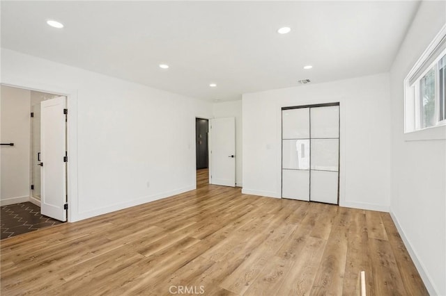 3427 S Victoria Ave, Los Angeles, CA 90016 - unfurnished bedroom featuring baseboards, recessed lighting, wood finished floors, and visible vents