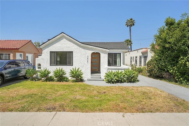 3427 S Victoria Ave, Los Angeles, CA 90016 - view of front of home with a front yard and stucco siding