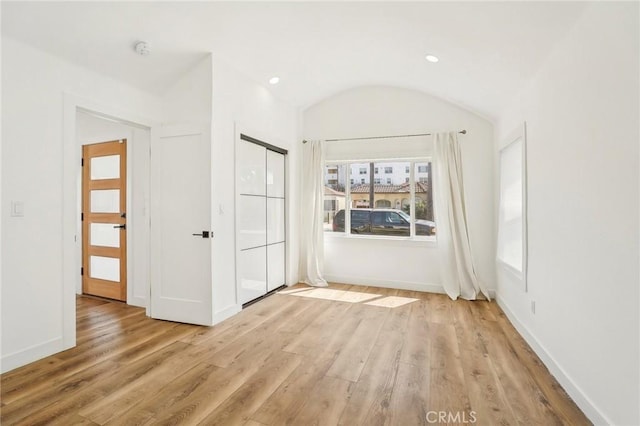 3427 S Victoria Ave, Los Angeles, CA 90016 - unfurnished bedroom featuring baseboards, light wood finished floors, and lofted ceiling