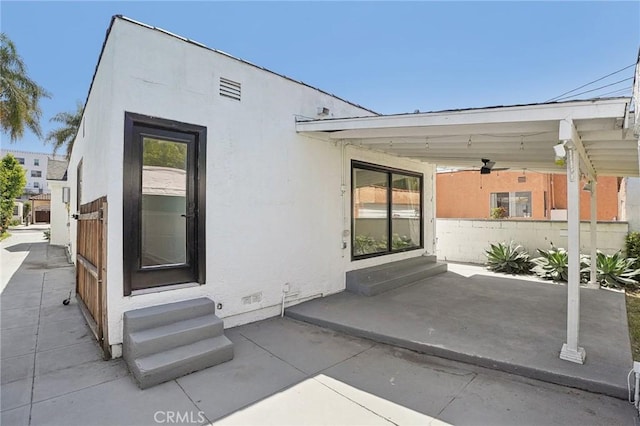 3427 S Victoria Ave, Los Angeles, CA 90016 - back of house featuring entry steps, ceiling fan, a patio area, and stucco siding