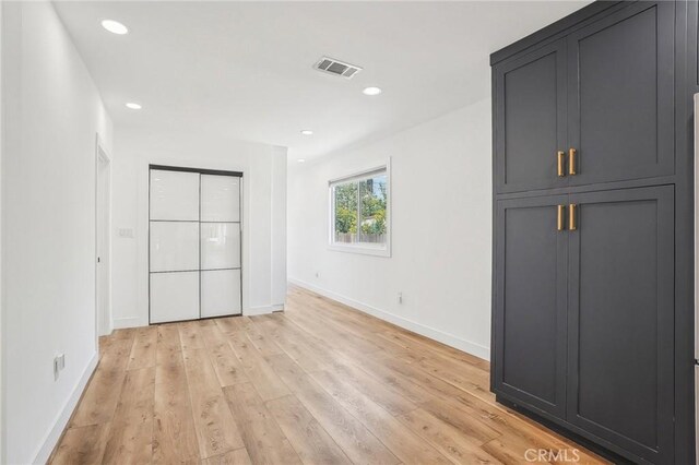 3427 S Victoria Ave, Los Angeles, CA 90016 - unfurnished bedroom with recessed lighting, baseboards, light wood-type flooring, and visible vents
