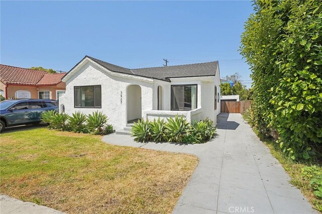 3427 S Victoria Ave, Los Angeles, CA 90016 - view of front facade featuring fence, a front lawn, and stucco siding
