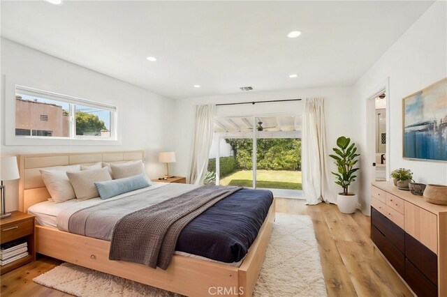 3427 S Victoria Ave, Los Angeles, CA 90016 - bedroom with light wood-type flooring, recessed lighting, multiple windows, and access to exterior