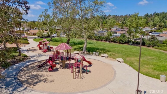surrounding community featuring a residential view, a yard, and playground community