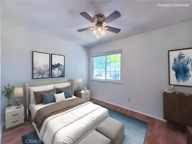 bedroom with baseboards, ceiling fan, and wood finished floors
