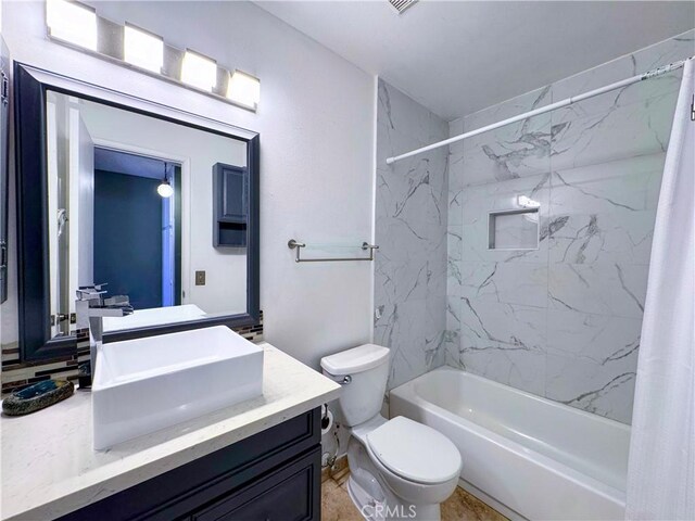 bathroom with toilet, bathtub / shower combination, and vanity