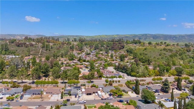 drone / aerial view featuring a residential view and a mountain view